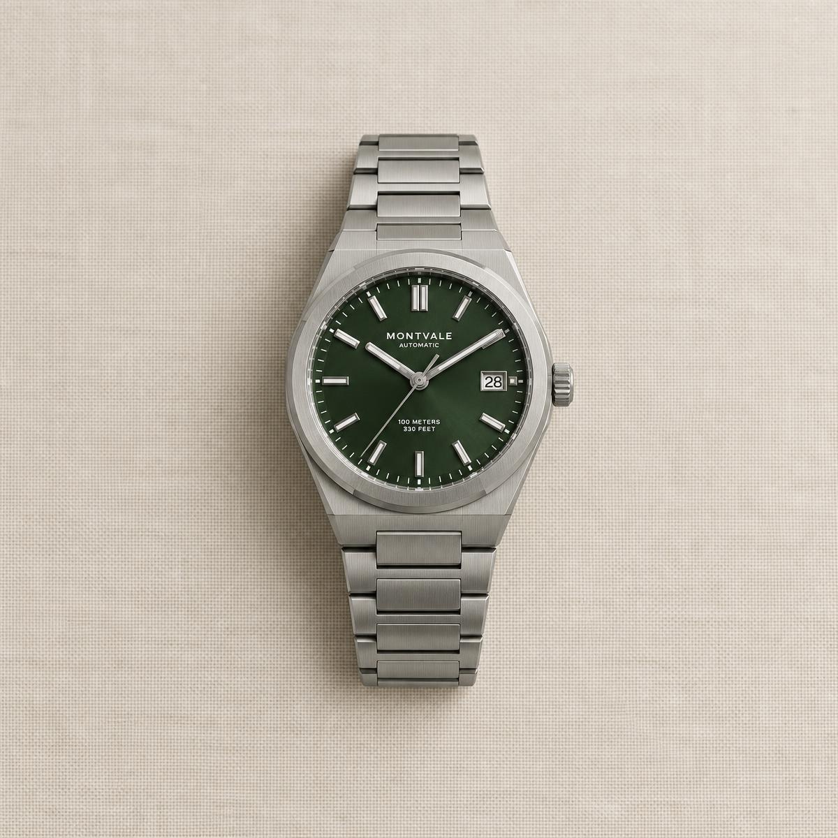 Steel sports watch with a green dial and integrated bracelet